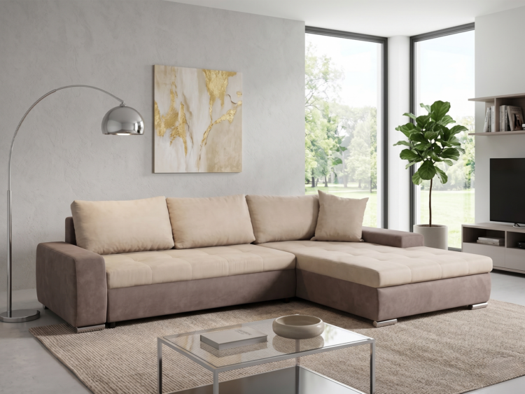 Beige sectional sofa in a bright modern living room with a glass coffee table, textured gray wall, and gold-accent artwork by large windows.