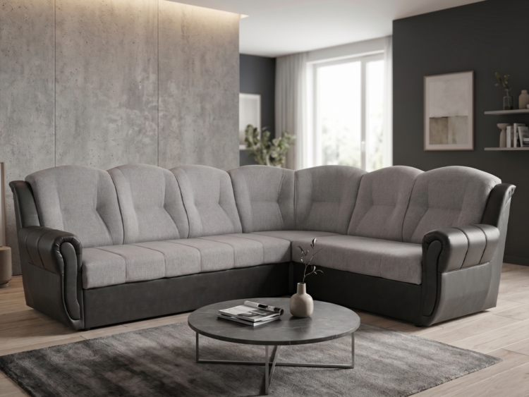 L-shaped gray sectional sofa in a modern living room with a round coffee table on a dark rug in front of the seating area.