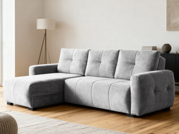 Grey modular sofa in a bright living room with a floor lamp and wooden floorboards.