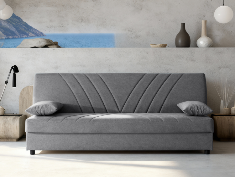 Gray upholstered sofa with diagonal stitch patterns in a modern living room, coastal mural behind it.