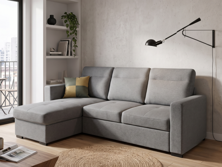 Modern living room with a grey L-shaped sofa, tufted cushions, and a round jute rug on a wooden floor.
