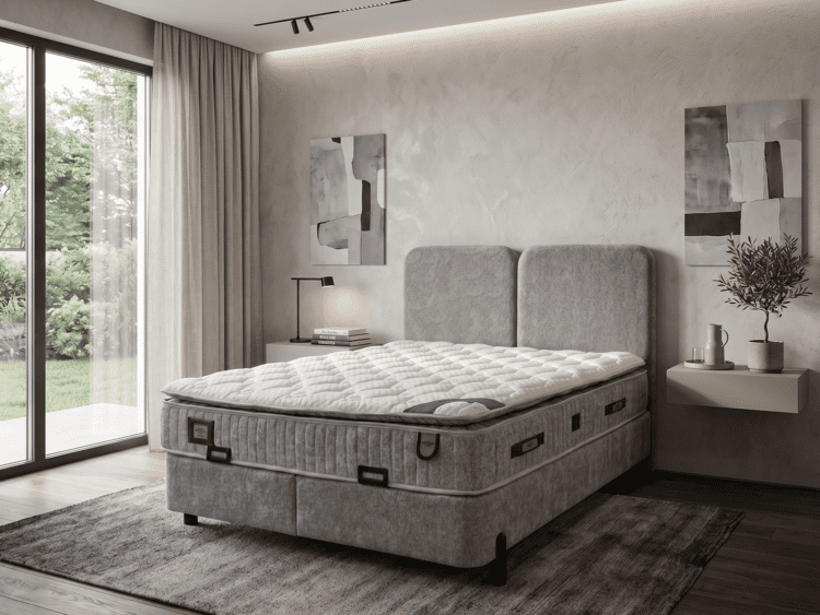 Modern gray bedroom with a plush upholstered bed, minimalist nightstands, and abstract wall art by a large window with sheer curtains to the left