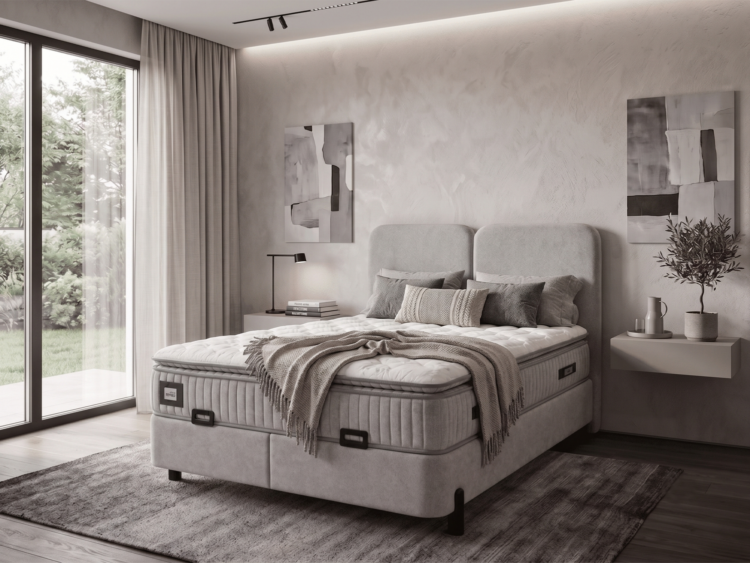 Modern bedroom with a large upholstered bed, two nightstands, abstract wall art, and a sliding glass door to a garden.