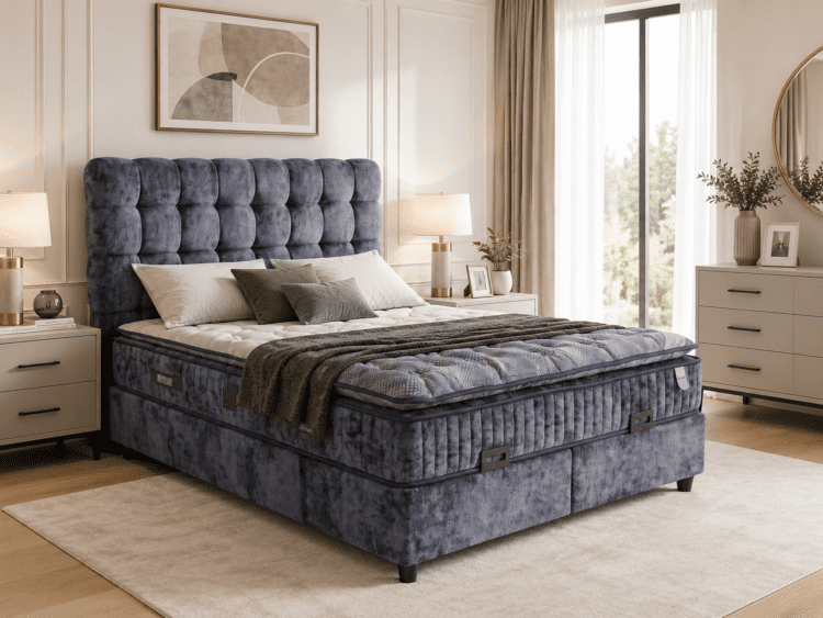 Blue velvet tufted king bed with white bedding, flanked by matching nightstands and lamps in a bright beige bedroom