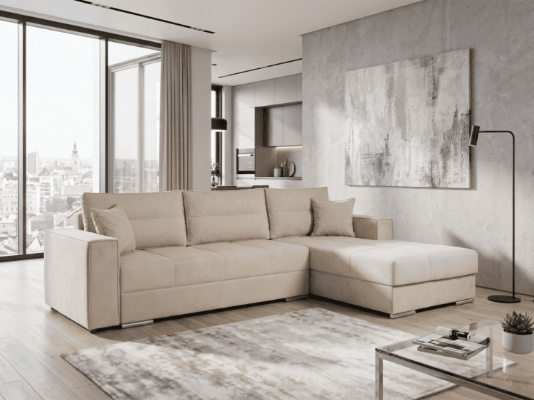 Large beige sectional sofa in a bright, modern living room with floor-to-ceiling windows and a cityscape view in the background
