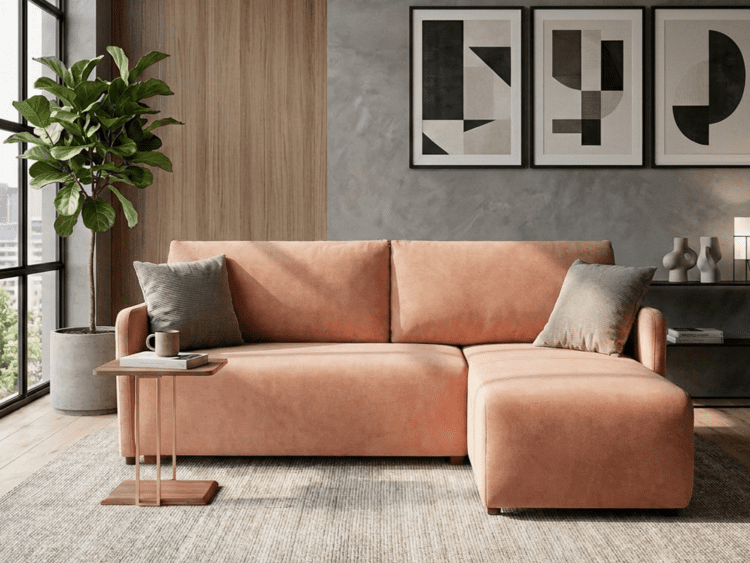 Modern living room with a peach velvet sectional, tall potted plant by a window, and geometric abstract art above a gray wall.