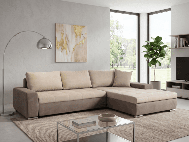 Beige sectional sofa in a bright modern living room with a glass coffee table, textured gray wall, and gold-accent artwork by large windows.