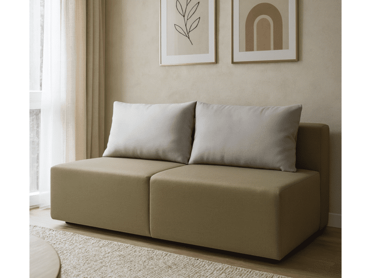 Beige modular sofa with two light gray pillows in a sunlit living room.
