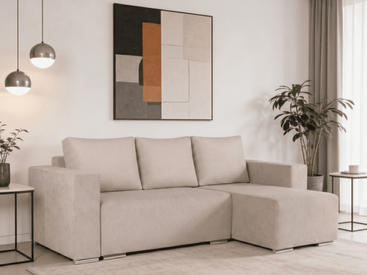 Beige L-shaped sofa in a bright living room with abstract geometric wall art and a tall plant nearby.