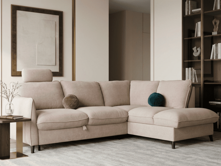 Blush pink L-shaped sofa with two round cushions in a modern living room.