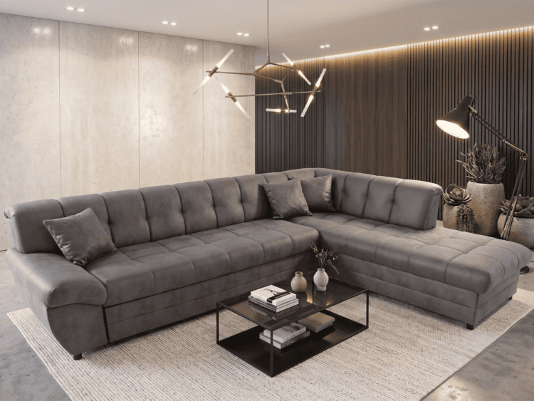 Contemporary living room with a large gray L-shaped sectional sofa, beige rug, and a black glass coffee table with books and vases.