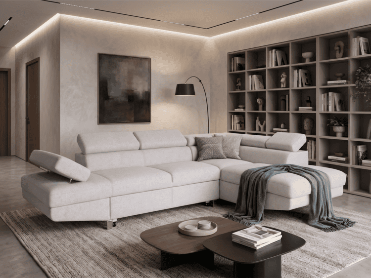 Contemporary living room with a light gray sectional sofa, chaise, and a dark arc floor lamp beside a tall bookshelf wall.