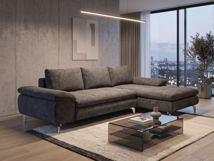 Modern gray sectional sofa in a chic living room with a glass coffee table and a city skyline through floor-to-ceiling windows on the right.