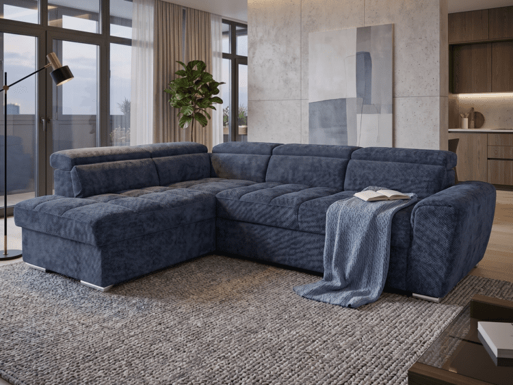 Blue modular sofa in a bright modern living room with a blanket and open book on the armrest.