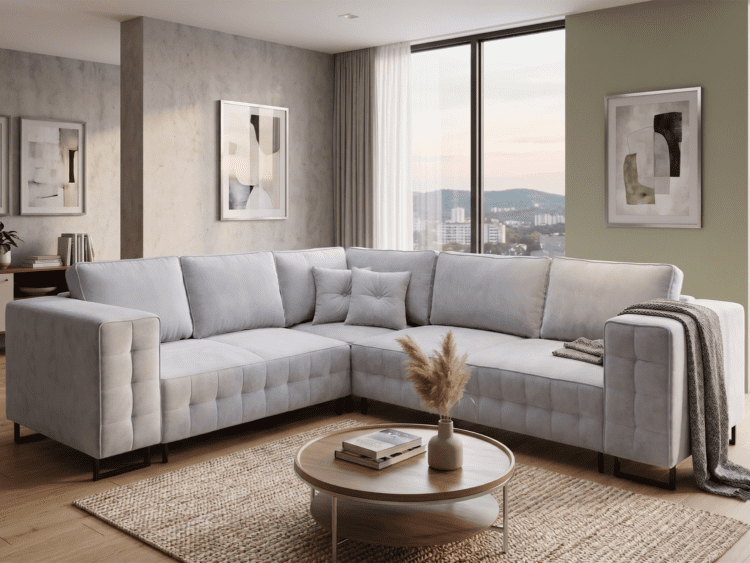 L-shaped light-gray sectional sofa in a modern living room with abstract wall art and big windows overlooking a cityscape and hills