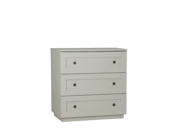 Cream-colored, four-drawer dresser with round metal knobs for bedroom storage